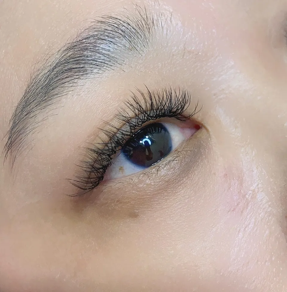 Eyelash extension close-up showcasing natural-looking volume lashes